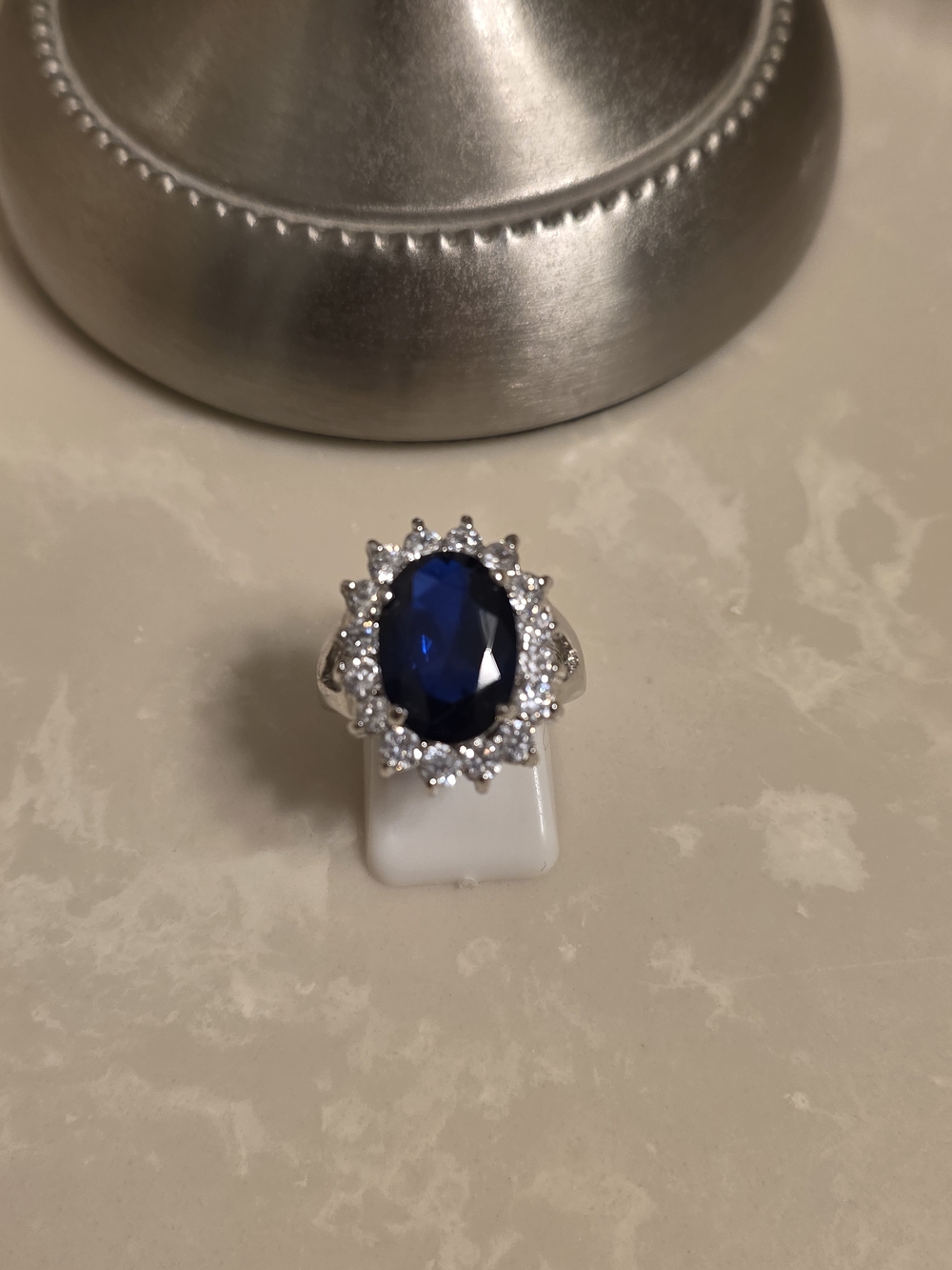 Silver Ring with Deep Blue Oval Center and Halo Accents